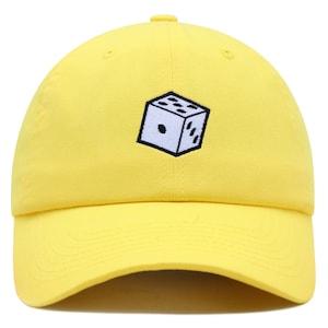 May include: A yellow baseball cap with a black and white embroidered dice design.