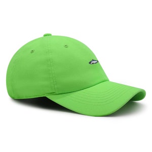 May include: A bright green baseball cap with a curved brim. The cap features a small embroidered fish on the front. The hat is made of a soft fabric and has a classic six-panel design.