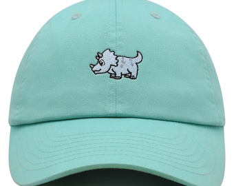 May include: A turquoise blue baseball cap with an embroidered cartoon triceratops on the front.