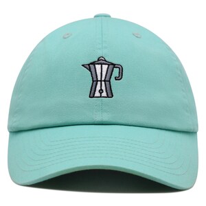May include: A light blue baseball cap with an embroidered image of a silver coffee pot.