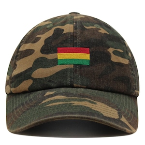 May include: A camouflage baseball cap with a small embroidered flag of Bolivia on the front. The flag is red, yellow, and green.