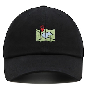 May include: A black baseball cap with an embroidered map and a red pin on the front.