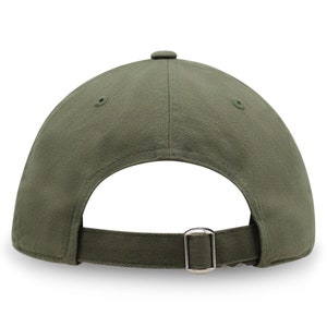 May include: A green baseball cap with a buckle closure on the back.