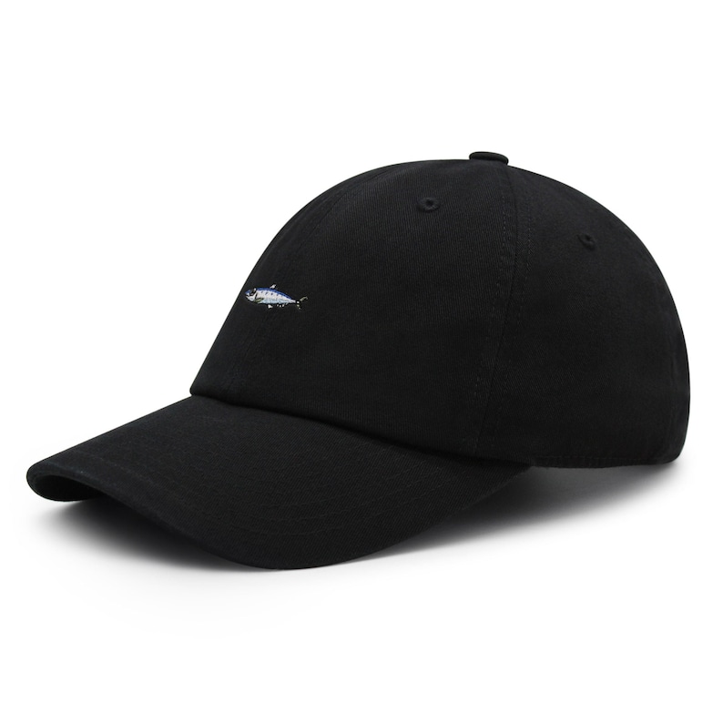 May include: Black baseball cap with a curved brim. The cap features a small embroidered fish on the front. The hat is made of a soft fabric and has a classic, casual style.