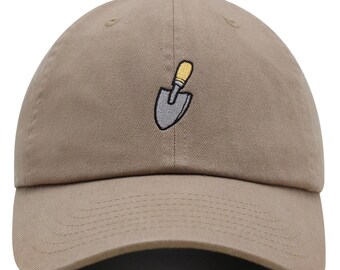 May include: A khaki baseball cap with a small embroidered image of a grey shovel with a yellow handle.