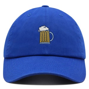 May include: A royal blue baseball cap with an embroidered image of a yellow beer mug with white foam on top.