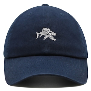 May include: A navy blue baseball cap with a white embroidered fish skeleton design.