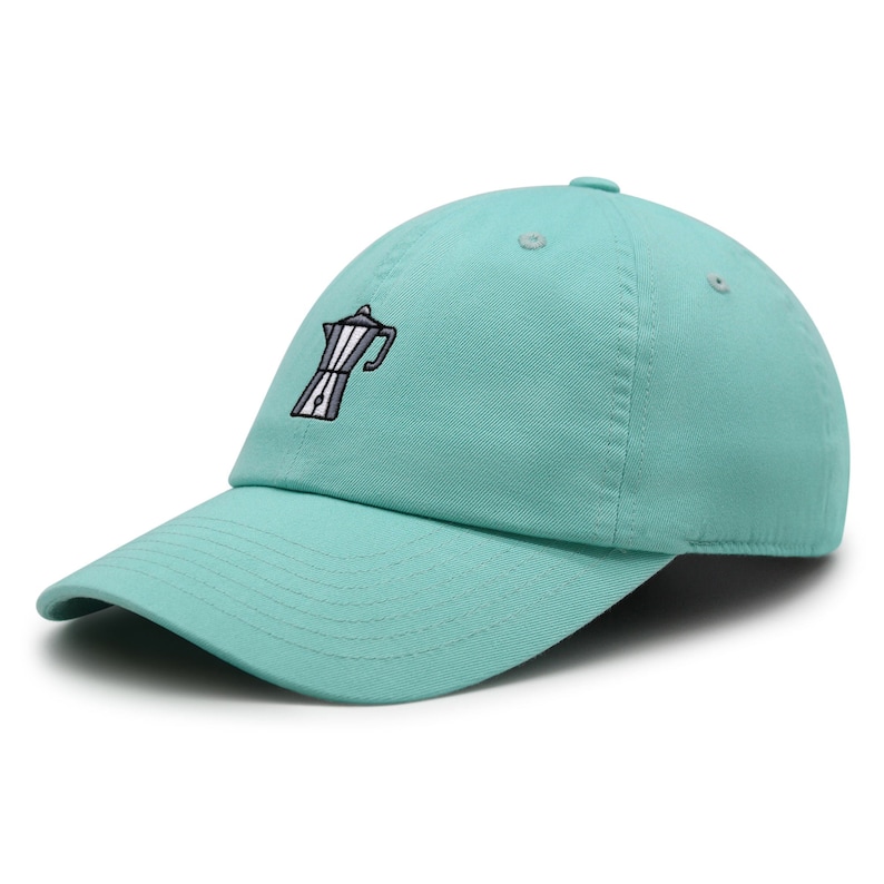 May include: A turquoise blue baseball cap with an embroidered image of a coffee pot.