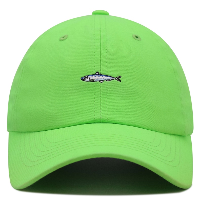 May include: Bright green baseball cap with a curved brim. The cap features a small embroidered sardine design in blue, white, and black on the front. The cap is made of a soft fabric and has a classic six-panel design.