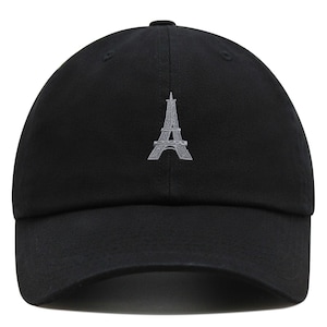 May include: A black baseball cap with an embroidered gray Eiffel Tower design.