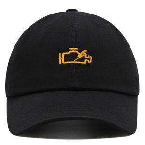 May include: A black baseball cap with a yellow embroidered check engine light symbol.