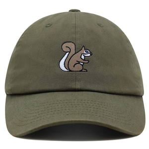 May include: A green baseball cap with an embroidered brown squirrel with a white tail and blue eyes.