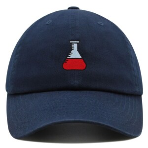 May include: A navy blue baseball cap with an embroidered red and white beaker on the front.