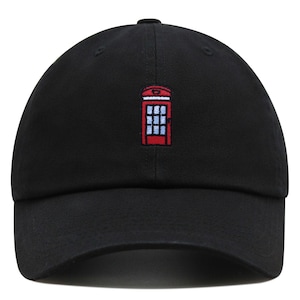 May include: Black baseball cap with a red telephone booth embroidered on the front.