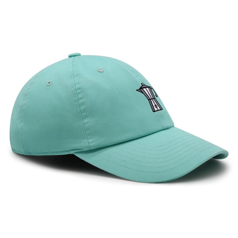 May include: A turquoise blue baseball cap with an embroidered image of a coffee pot on the front.
