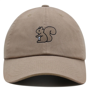 May include: A tan baseball cap with an embroidered brown squirrel design.