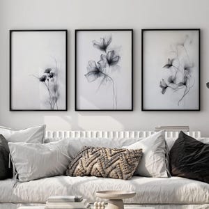 Minimalistische florale Wandkunst 3er-Set - Zarte Graphitlinien-Blumenskizzendrucke, monochromes botanisches Posterdekor für ein modernes Zuhause