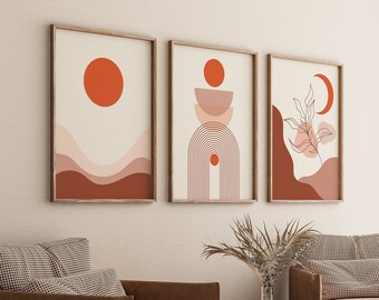 May include: Three framed abstract art prints with a minimalist design. The prints feature geometric shapes, lines, and a crescent moon in shades of orange, pink, and brown.