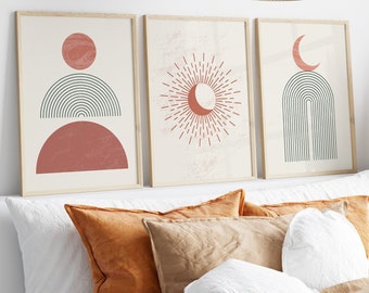 May include: Three framed prints with abstract geometric designs in shades of red, green, and white. The prints feature a crescent moon, a sun with rays, and a half circle with a rainbow arch.