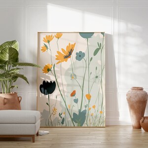 May include: A framed floral art print featuring stylized yellow, blue, and black flowers with green foliage against a light background. The artwork is displayed in a room with a potted plant, a footstool, and terracotta vases.
