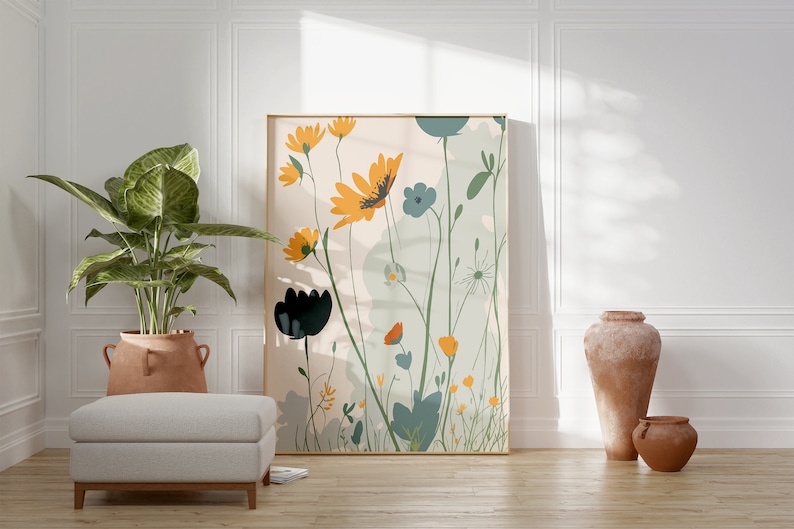 May include: A framed floral art print featuring stylized yellow, blue, and black flowers with green foliage against a light background. The artwork is displayed in a room with a potted plant, a footstool, and terracotta vases.
