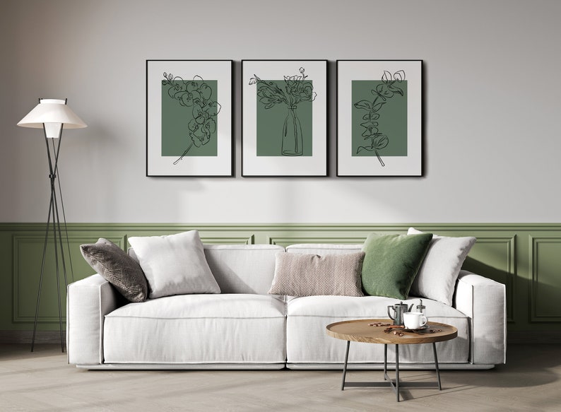 May include: Three black framed prints with white mounts and green backgrounds featuring line drawings of flowers and greenery.