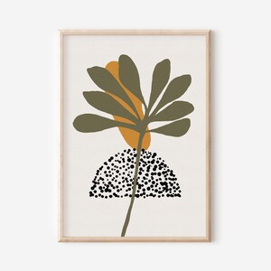 May include: Abstract art print featuring a stylized green plant with a yellow-orange shape behind it. The plant is growing from a black and white polka dot shape.