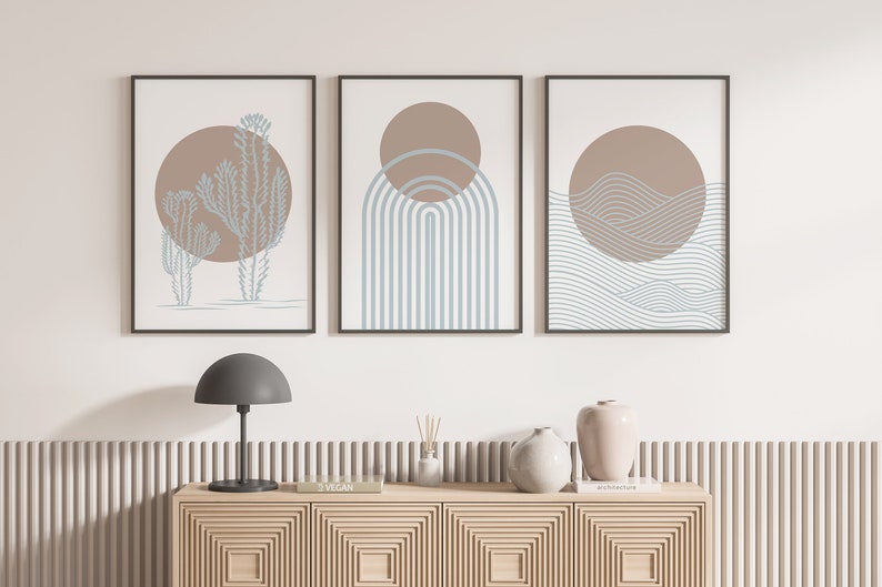 May include: Three minimalist art prints with a brown and blue color scheme. The prints feature a cactus, a rainbow, and waves.