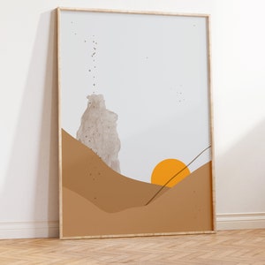 May include: A framed abstract art print with a beige, brown, and orange color scheme. The print features a stylized landscape with a sun setting over hills.