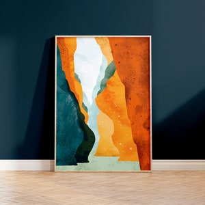 May include: Abstract art print featuring a canyon scene with orange, yellow, blue, and green colors. The print is framed in a light wood frame.