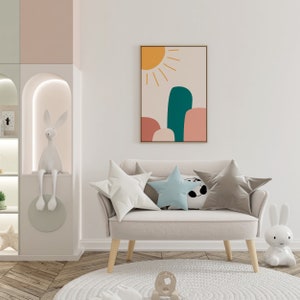 May include: A child's room with a beige loveseat, star-shaped pillows, and a framed abstract art piece. The art features a yellow sun and colorful shapes. A white rug and decorative bunny figures complete the scene.