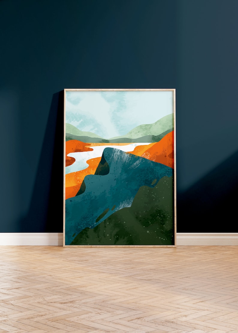 May include: Abstract landscape painting in a wooden frame. The painting features a blue, green, and orange color scheme with a river flowing through the center.
