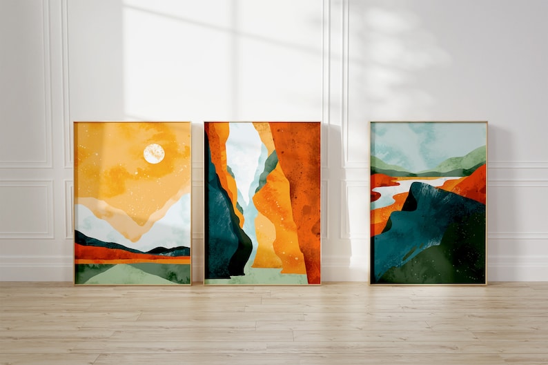 May include: Three abstract landscape paintings in gold frames. The paintings feature a variety of colors, including yellow, orange, blue, and green. The paintings are hung on a white wall.