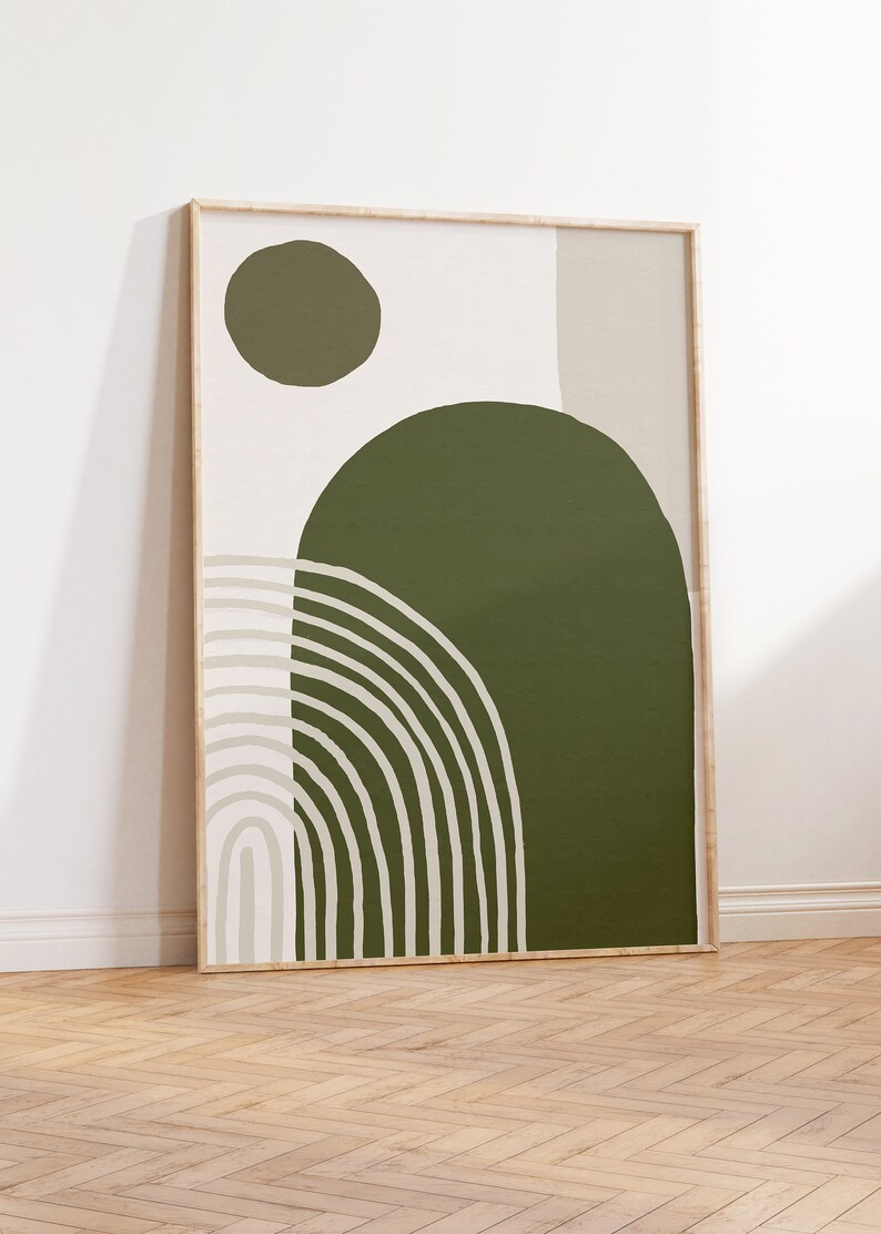 May include: Abstract art print with a green, beige, and white color scheme. The print features a large green circle with a smaller green circle and a beige rectangle in the background. The print is framed in a light wood frame.