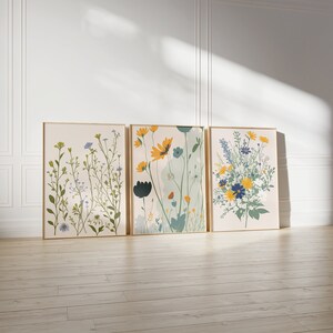 Set of three botanical wildflower prints with yellow, blue, and green meadow flowers for cottagecore or nature-inspired home decor.