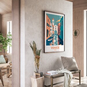 May include: A colorful illustration of a canal in Venice, Italy. The image features buildings with orange, pink, and blue facades, and boats on the water. The text "VENICE ITALY" is printed below the image.