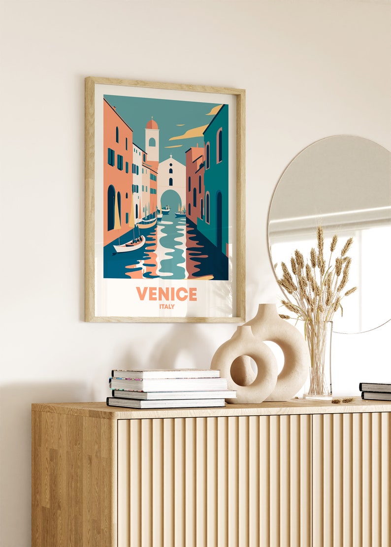May include: A framed illustration of a canal in Venice, Italy. The illustration features colorful buildings, boats, and a blue sky. The text "VENICE ITALY" is printed below the illustration.