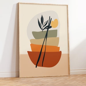 May include: Abstract art print featuring a stack of four bowls in shades of green, orange, and brown, with a black silhouette of a plant and chopsticks in the centre. The background is a light beige colour.