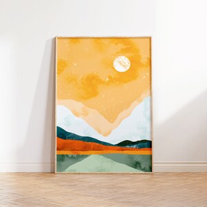 May include: A framed abstract landscape painting with a yellow, orange, and green color scheme. The painting depicts a mountain range with a large white circle in the sky.
