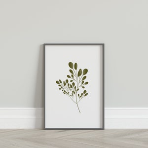May include: A framed print of a stylised green leaf branch on a white background. The frame is grey.