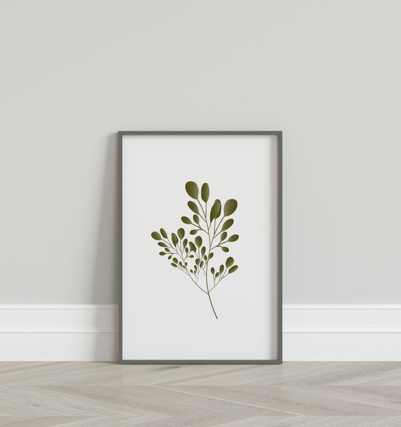 May include: A framed print of a stylised green leaf branch on a white background. The frame is grey.