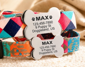 May include: Two pet collars featuring colorful geometric patterns in shades of red, blue, orange, and teal. Each collar includes a silver-toned, bone-shaped metal tag engraved with the name MAX, a phone number, and the address 9 Puppy St Doggieland, US.