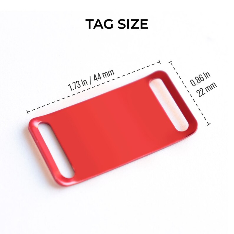May include: Red metal dog tag with rounded edges and two holes for attaching to a collar. The tag measures 1.73 inches by 0.86 inches.