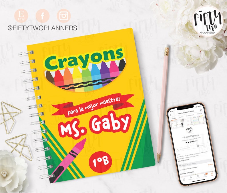 May include: A yellow and green spiral notebook with a colorful crayon box design. The notebook says "Crayons" in red letters and "para la mejor maestra! MS. Gaby 1&deg;B" in black letters.