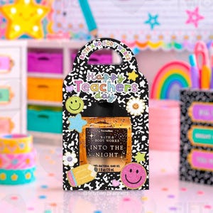 May include: A gift set for teachers featuring a PocketBac hand gel in a decorative holder. The holder is black and white with the words "Happy Teacher's Day" and decorative smiley faces, stars, and flowers. The hand gel is "Into the Night".
