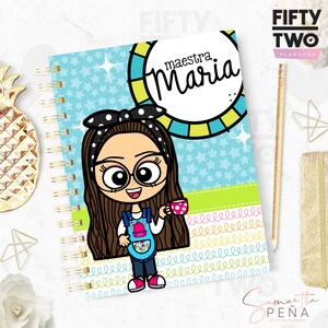 May include: Spiral-bound planner with a cartoon illustration of a woman wearing glasses and a polka-dot headband. The planner cover features the name "maestra Maria" in a circle and a light blue background with stars.