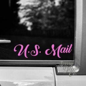May include: Pink vinyl decal with the text "U.S. Mail" in a cursive font. The decal is on a black background.