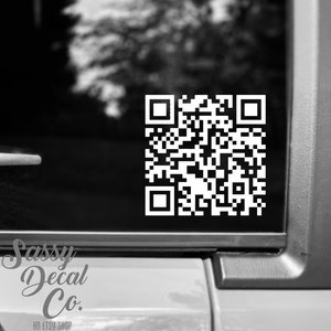 May include: A black and white QR code sticker on a black surface. The sticker has the text "Sassy Decal Co. An Etsy Shop" below it.