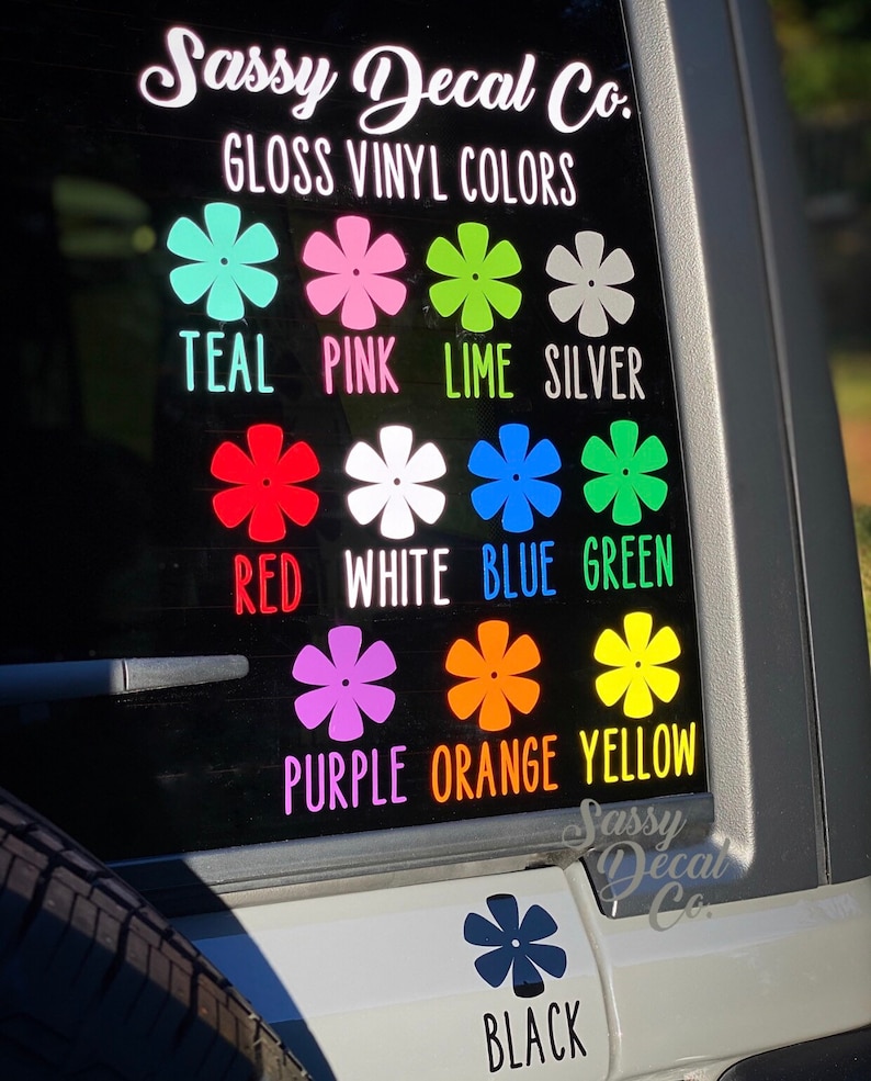 May include: A decal sheet with a variety of colors, including teal, pink, lime, silver, red, white, blue, green, purple, orange, yellow, and black. The decal sheet is labeled "Sassy Decal Co. Gloss Vinyl Colors".