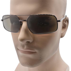 May include: Dark grey aviator sunglasses with a double bridge and rectangular lenses. The frames are a metallic grey color. The lenses are a dark, reflective grey. The sunglasses are displayed on a mannequin head.